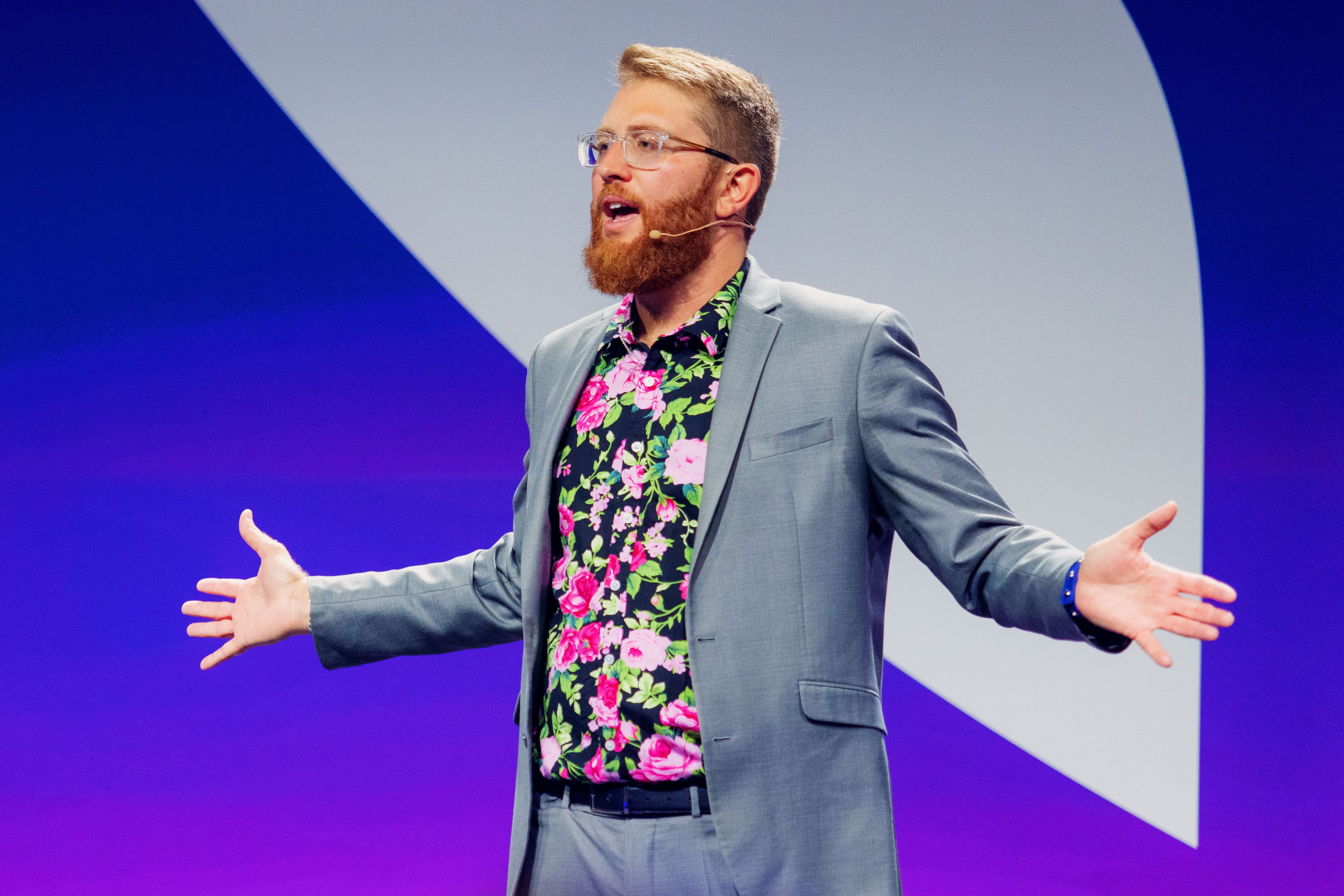 Carl Case speaking on the main stage at Mindvalley, delivering a keynote presentation.